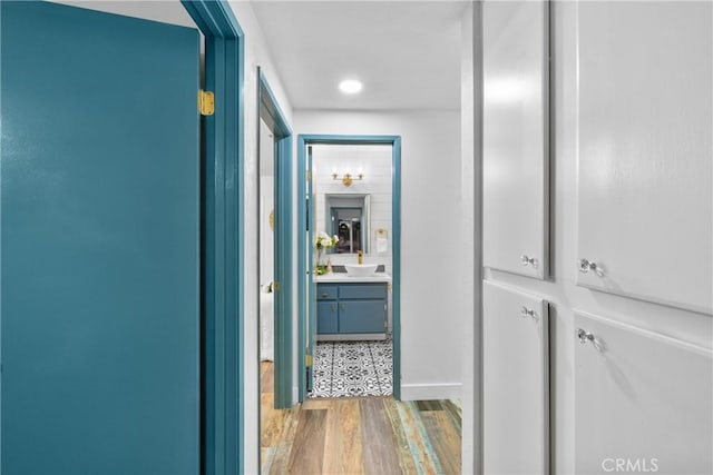 corridor with hardwood / wood-style flooring