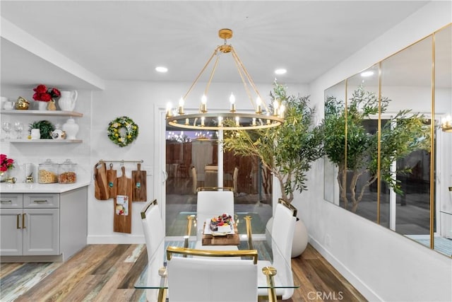 dining room with dark hardwood / wood-style floors and a notable chandelier