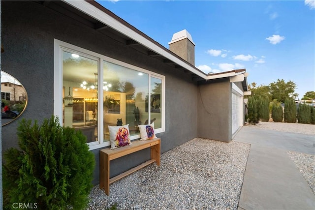 view of property exterior featuring a garage and a patio area