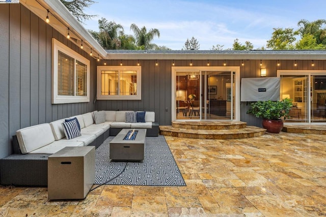 view of patio featuring an outdoor living space with a fire pit