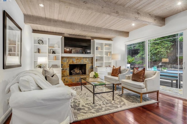 living room featuring hardwood / wood-style floors, beam ceiling, a fireplace, and wooden ceiling