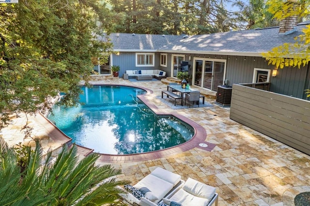 view of swimming pool featuring cooling unit, a patio area, and outdoor lounge area