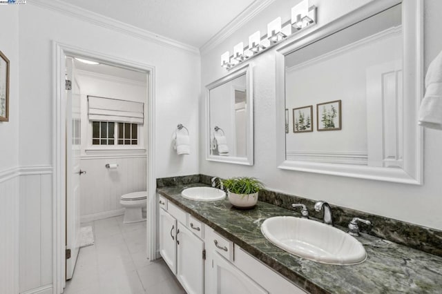 bathroom with ornamental molding, toilet, and vanity