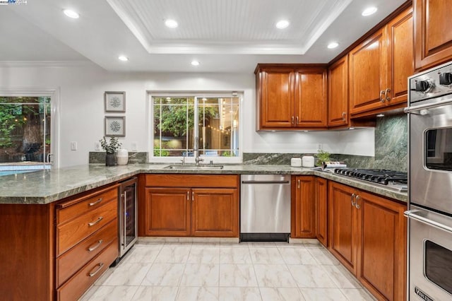 kitchen featuring a raised ceiling, sink, wine cooler, and kitchen peninsula