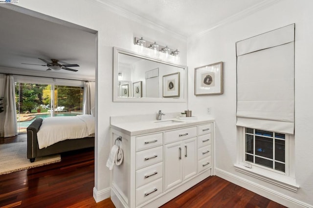 bathroom with crown molding, ceiling fan, vanity, and hardwood / wood-style floors