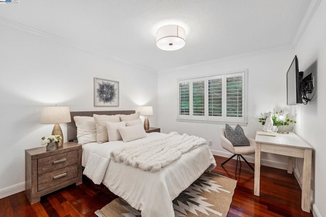 bedroom with ornamental molding and dark hardwood / wood-style floors