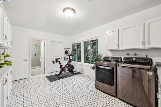 washroom featuring separate washer and dryer and cabinets