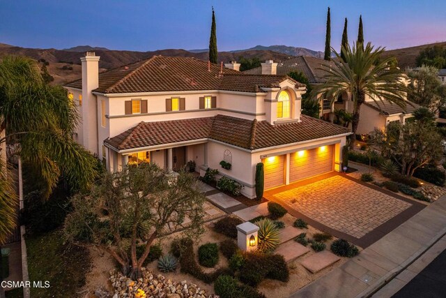 mediterranean / spanish home featuring a garage and a mountain view