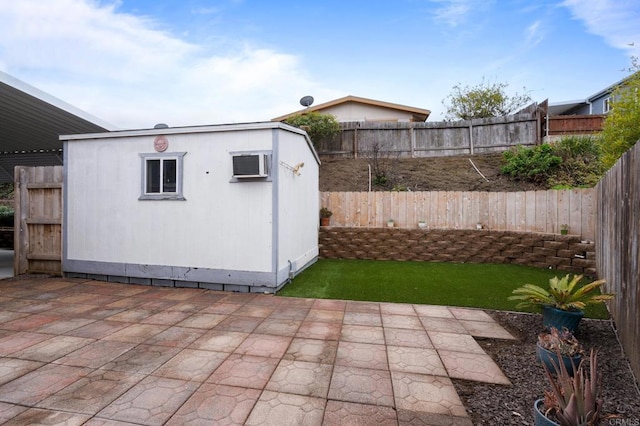 view of patio featuring a storage unit and an AC wall unit