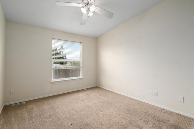 carpeted spare room with ceiling fan