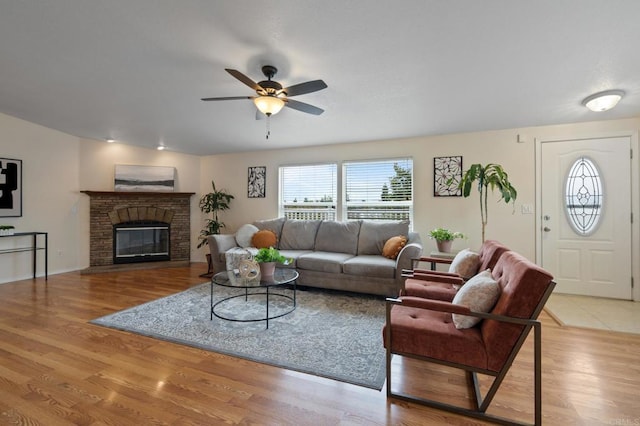 living room featuring ceiling fan and light hardwood / wood-style flooring