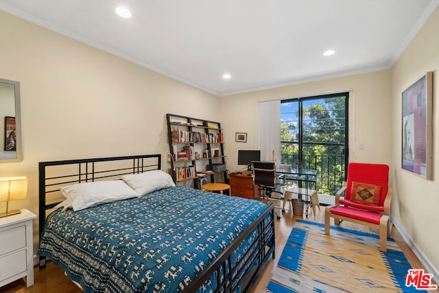 bedroom featuring crown molding, wood-type flooring, and access to exterior