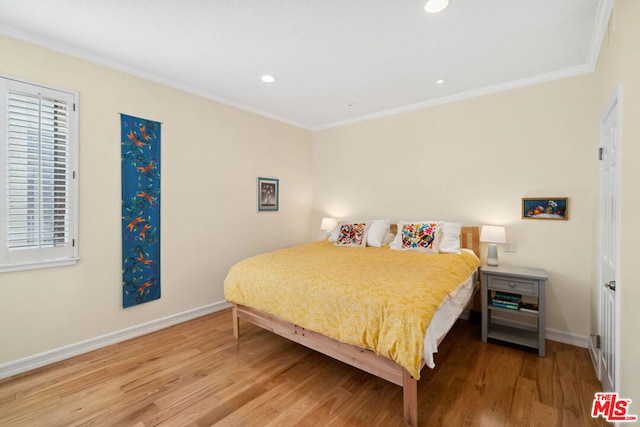 bedroom featuring ornamental molding and hardwood / wood-style floors