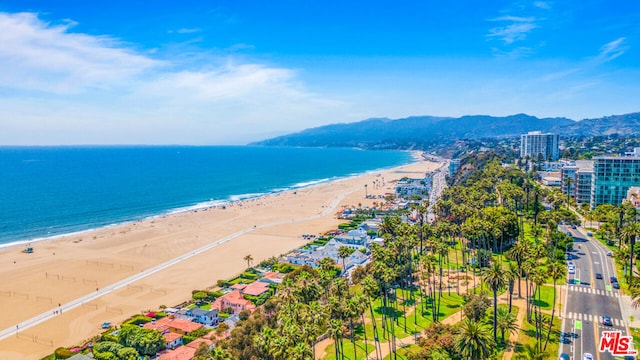 birds eye view of property featuring a view of the beach and a water and mountain view