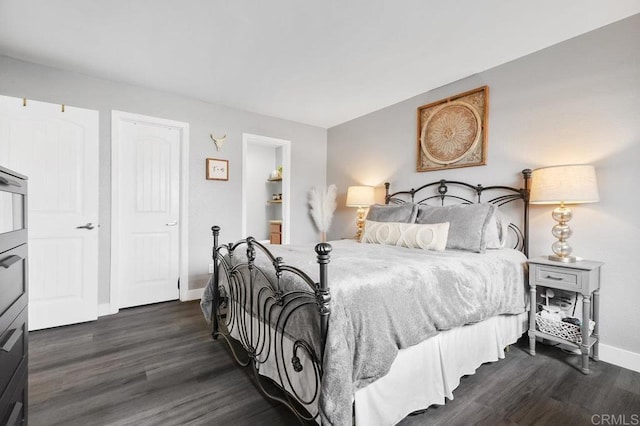 bedroom featuring dark wood-style flooring and baseboards