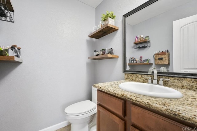 bathroom with toilet and vanity