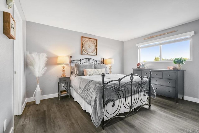 bedroom with baseboards and wood finished floors