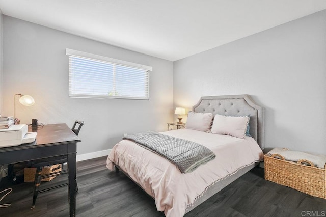 bedroom featuring dark wood-style floors and baseboards