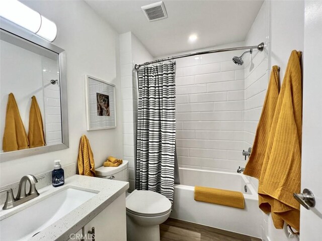 1137 Tiffany Cir S, Palm Springs, CA 92262 - bathroom featuring vanity, toilet, wood finished floors, and shower / tub combo