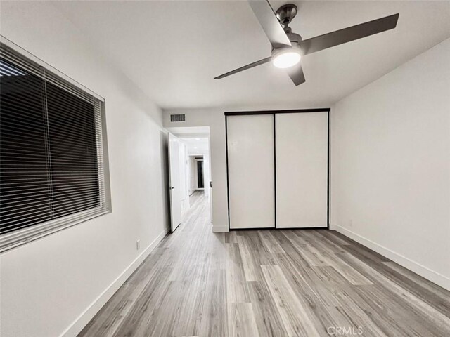 1137 Tiffany Cir S, Palm Springs, CA 92262 - unfurnished bedroom featuring light wood finished floors, a closet, baseboards, and a ceiling fan