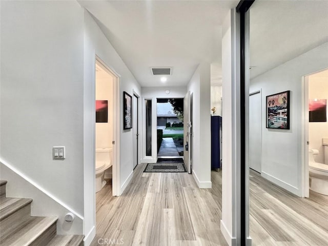 1137 Tiffany Cir S, Palm Springs, CA 92262 - hall featuring light wood-type flooring, baseboards, and stairway