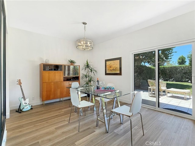 1137 Tiffany Cir S, Palm Springs, CA 92262 - dining space featuring light wood-style floors and a chandelier