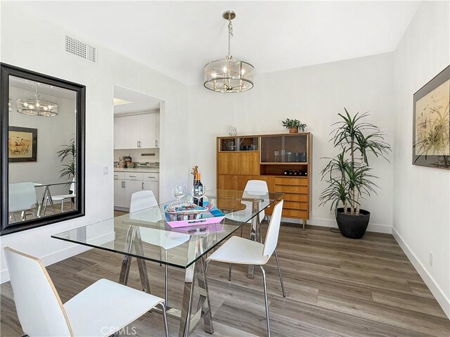 1137 Tiffany Cir S, Palm Springs, CA 92262 - dining room with a chandelier and wood finished floors