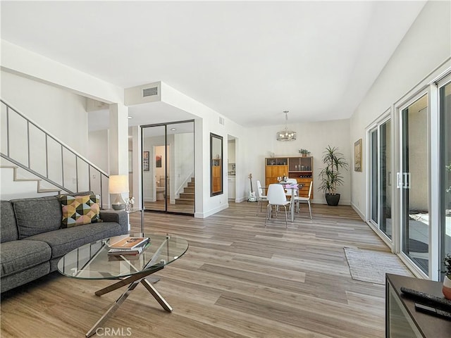 1137 Tiffany Cir S, Palm Springs, CA 92262 - living room featuring stairs, light wood finished floors, and a chandelier