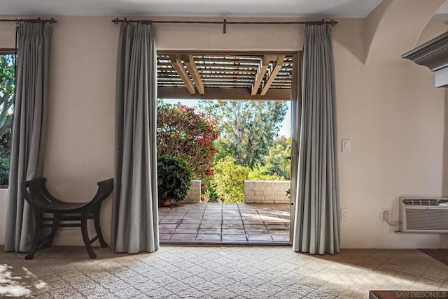 doorway to outside with a wall mounted AC