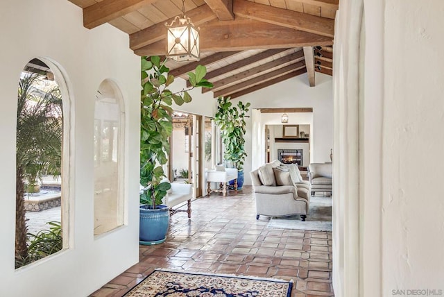 interior space featuring lofted ceiling with beams and a healthy amount of sunlight