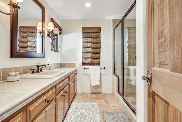 bathroom featuring vanity, an enclosed shower, and tile patterned floors