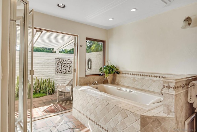 bathroom featuring a relaxing tiled tub and tile patterned floors