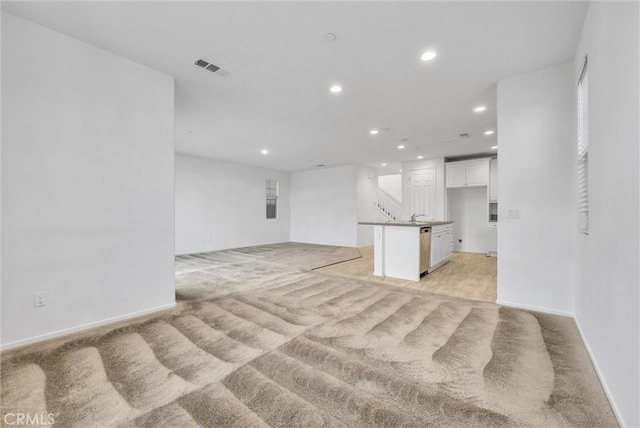 unfurnished living room with light carpet