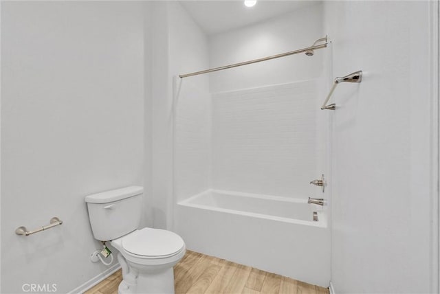 bathroom featuring shower / bath combination, wood-type flooring, and toilet