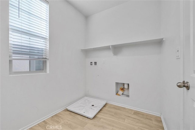 washroom with hookup for a washing machine and light wood-type flooring