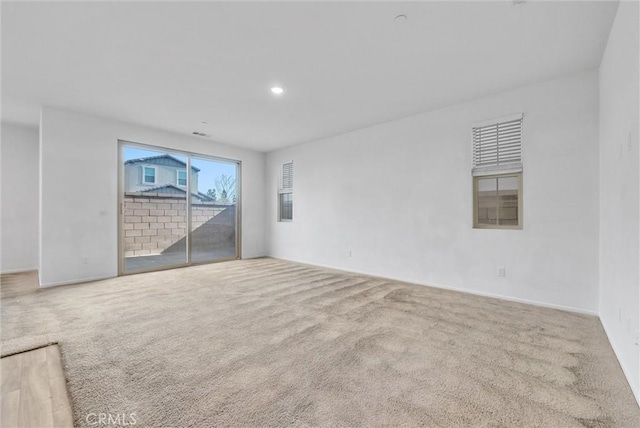 empty room featuring light colored carpet