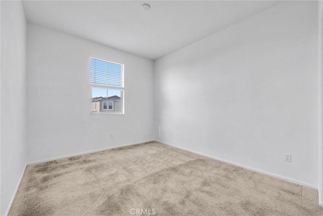 spare room with light colored carpet