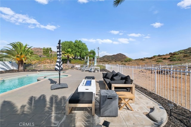 view of patio / terrace featuring a mountain view and a fenced in pool