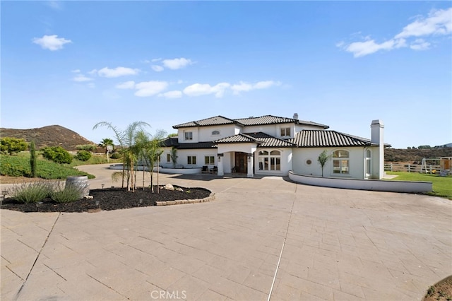 mediterranean / spanish house with a mountain view