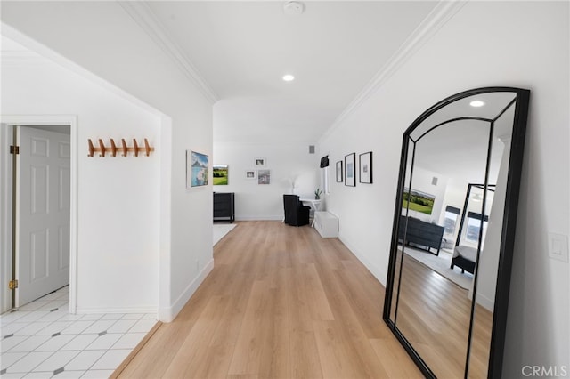 hall with light hardwood / wood-style flooring and ornamental molding