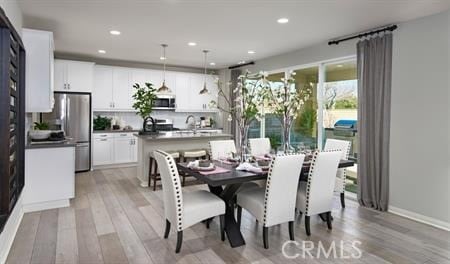 dining space with light hardwood / wood-style floors