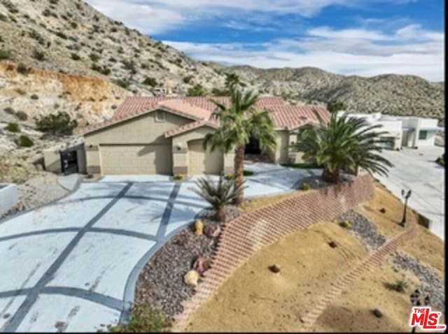 view of front of home featuring a mountain view and a garage