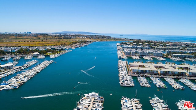 drone / aerial view featuring a water and mountain view