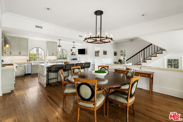 dining room with ornamental molding, a chandelier, and dark hardwood / wood-style flooring