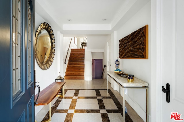 entrance foyer with a raised ceiling