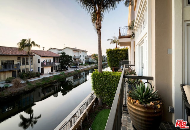 balcony at dusk with a water view