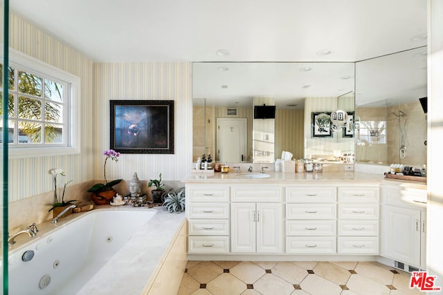 bathroom featuring vanity and independent shower and bath