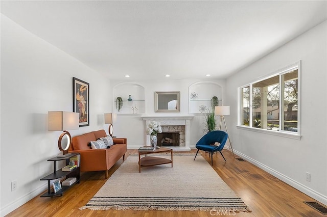 sitting room with hardwood / wood-style flooring