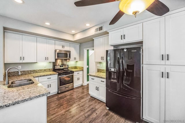 kitchen featuring stainless steel appliances, dark hardwood / wood-style floors, sink, and white cabinets