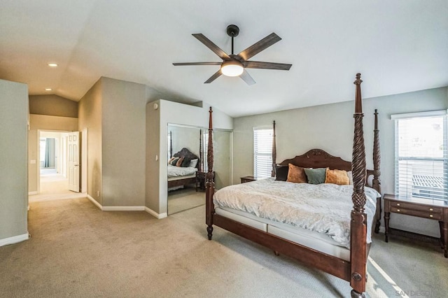 bedroom with lofted ceiling, light colored carpet, ceiling fan, and a closet